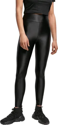 A person wearing black leggings and black shoes, shown from the waist down against a white background.