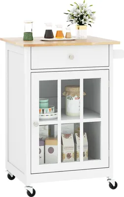 A white kitchen cart with a wooden top is shown against a white background. It has a drawer, a glass-doored cabinet with shelves, and wheels.