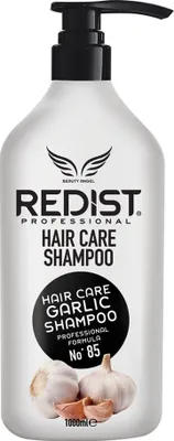 A bottle of shampoo with a pump dispenser, featuring images of garlic bulbs.