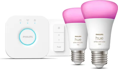 A Philips Hue starter kit including a bridge, a remote, and two smart light bulbs.