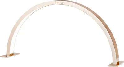 A metallic arched lamp with a white light source inside, standing on two flat bases.
