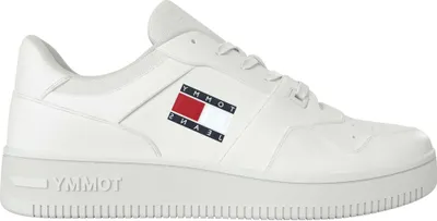 A side view of a white Tommy Jeans sneaker.