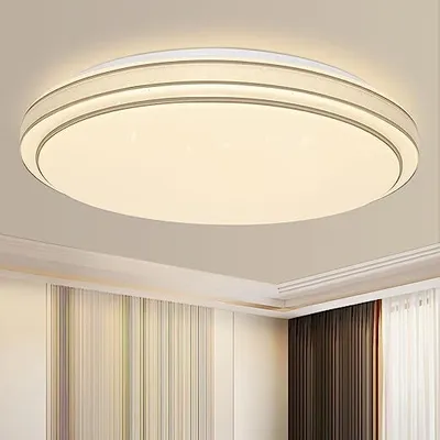 A modern, round LED ceiling light with a white diffuser and gray accents, mounted on a white ceiling.