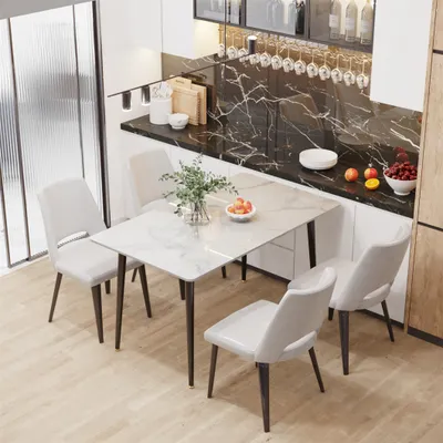 A dining table with chairs in a modern kitchen setting.