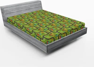 A fitted sheet with a cartoon road pattern is displayed on a bed frame.