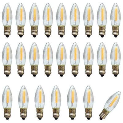 A collection of LED filament candle bulbs arranged in rows on a white background.