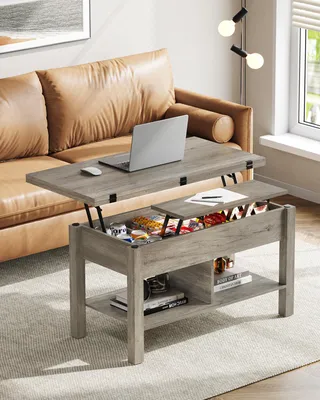 A lift-top coffee table with storage is shown in a living room setting next to a leather sofa.