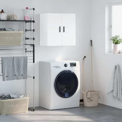 A laundry room with a washing machine, storage shelves, and a wall cabinet.
