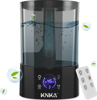 A black humidifier with a transparent water tank is shown against a white background. The humidifier has a digital display and a remote control is placed next to it. Decorative bubbles with leaves are overlaid on the image.