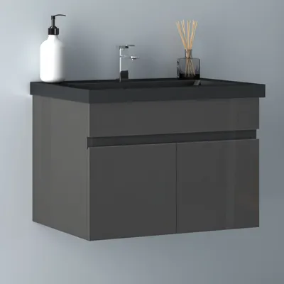 A wall-mounted bathroom vanity with a black countertop and basin, featuring two gray cabinet doors.
