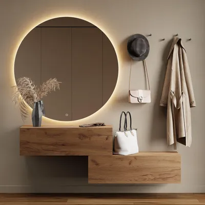 A modern entryway with a round illuminated mirror, wooden shelves, and hanging accessories.