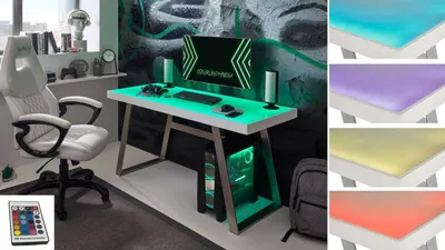 A gaming desk setup with a white chair, computer, and monitor, featuring customizable RGB lighting.