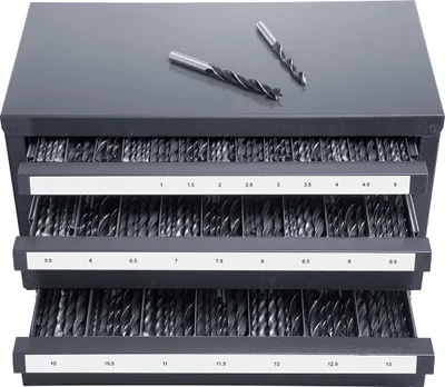 A gray metal cabinet with three drawers filled with drill bits. Two drill bits are placed on top of the cabinet.