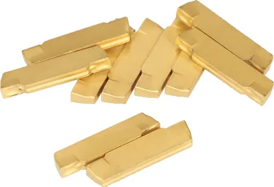 A group of gold-colored metal inserts are arranged on a white background.