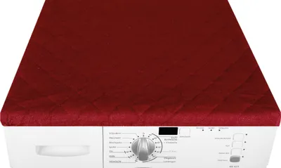 A red quilted cover is placed on top of a white washing machine.