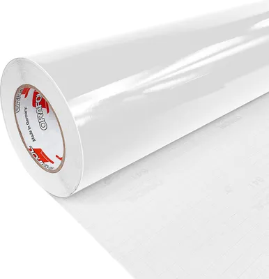 A roll of white glossy adhesive film is shown diagonally against a white background. The film is partially unrolled, revealing a grid pattern on the backing paper. The core of the roll has branding visible.