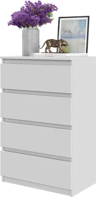 A white chest of drawers with decorative items on top.