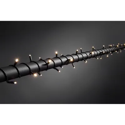 Zdjęcie produktu dla Konstsmide - Mikrolampki LED, z 9-godzinnym wyłącznikiem czasowym, izolowane / hermetyczne, IP67, 80 ciepłych białych diod, transformator zewnętrzny 24 V, czarny miękki kabel; 6631-117