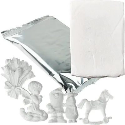 A collection of white plaster figures and a bag of white powder on a white background.