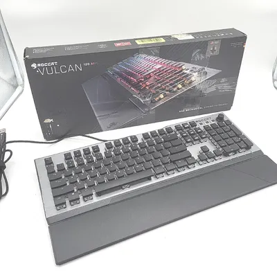 A Roccat Vulcan 120 AIMO keyboard and its packaging are displayed on a white background.