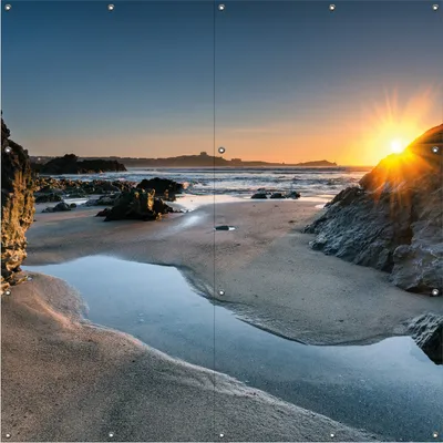Produktbild von Wallario Outdoor-Poster für Garten oder Balkon, Motiv Sonnenuntergang hinter einem Felsen am Strand, in ca. 180 x 180 cm