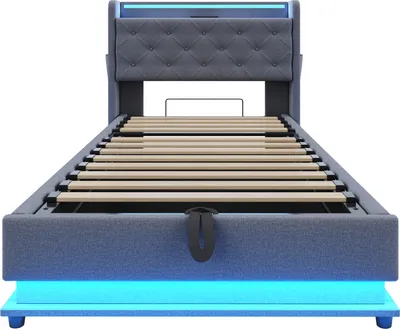 A studio shot of a bed frame with a headboard and slatted base, illuminated by blue LED lights.