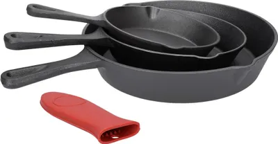 A set of three nested cast iron frying pans with a red silicone handle cover.