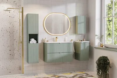 A modern bathroom with green vanity, mirror, and storage units.
