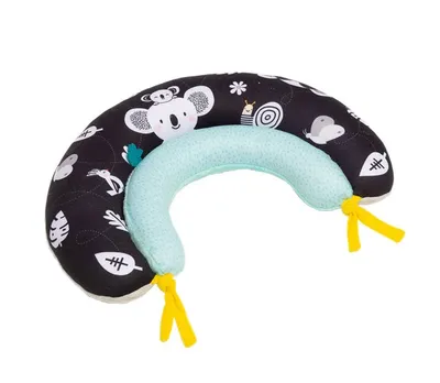 A baby pillow with a black and white pattern of animals and leaves, and a light blue inner cushion.