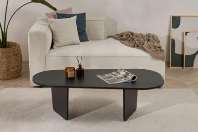 A modern living room scene with a couch, coffee table, and decor.