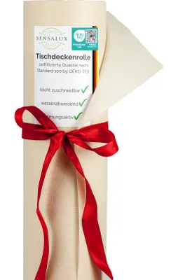 A roll of cream-colored tablecloth material tied with a red ribbon, with a label attached.