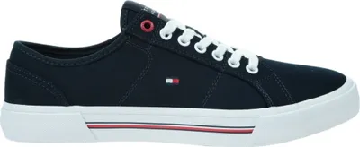 A side view of a navy blue Tommy Hilfiger sneaker with white laces and a white sole.
