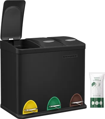 A black three-compartment recycling bin with colored pedals and a package of trash bags next to it.