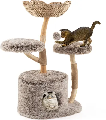 A cat tree with two cats on it, one playing with a toy and the other peeking out of a hole.