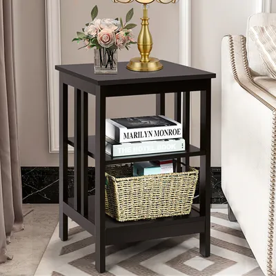 A dark brown wooden nightstand with three shelves, placed next to a sofa in a living room setting.