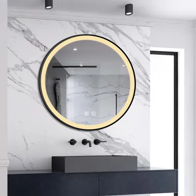 A modern bathroom vanity with a round LED mirror above a dark vanity and a gray sink.