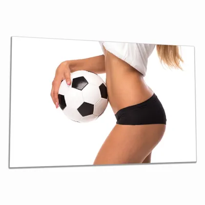 Produktbild von Wallario Herdabdeckplatte aus Glas, Größe 80 x 52 cm 1-teilig, Motiv Fußball - sexy Frau mit einem Fußball