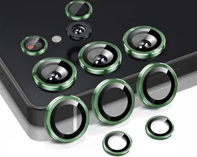 A collection of camera lens protectors for a smartphone, arranged on a dark surface.