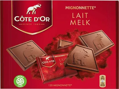 A box of Cote d'Or chocolates with several pieces of chocolate scattered around.