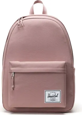 A pink Herschel backpack is shown against a white background.