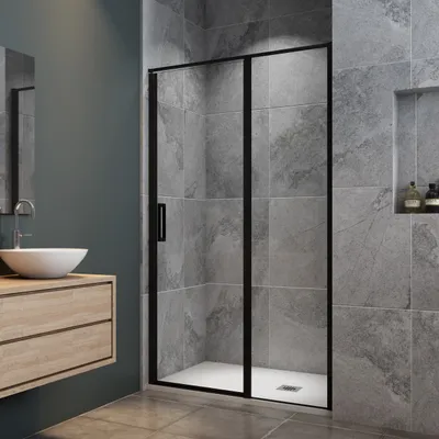 A modern bathroom with a shower enclosure, vanity, and sink.