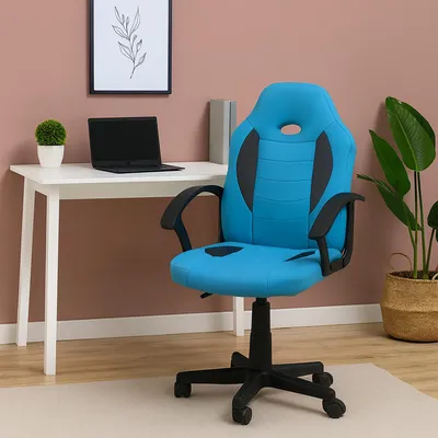 A blue gaming chair is placed next to a white desk with a laptop and a small plant.