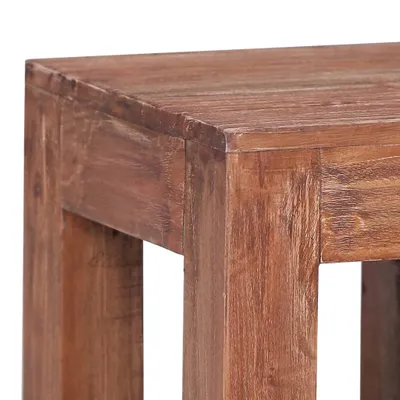 A close-up view of the corner of a wooden table.