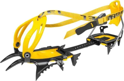A pair of yellow and black crampons on a white background.