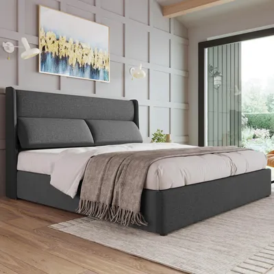 A bedroom scene with a bed, artwork, and a window overlooking a garden.