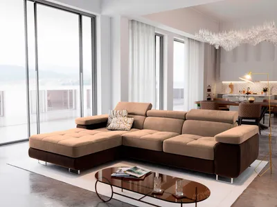 A modern living room with a large sectional sofa, coffee table, and large windows.