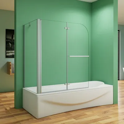 A shower screen and bathtub in a bathroom with green walls and a wooden floor.