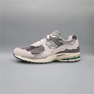 A single New Balance 2002R Protection Pack shoe is shown against a plain gray background.