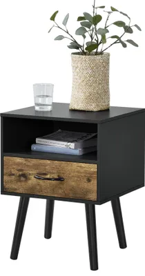 A black and wood-tone nightstand with a drawer and an open shelf, decorated with a plant in a woven pot and a glass of water on top.