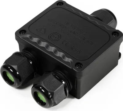 A black, rectangular junction box with three cable glands, two on one side and one on the opposite side. The box has text and symbols embossed on its top surface.